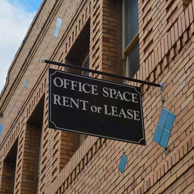 Building with a sign that says "Office Space Rent or Lease."