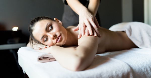 woman laying on table getting a sports massage