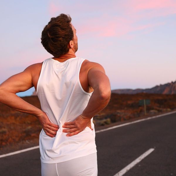 Runner experiencing lower back pain in need of a sports massage.