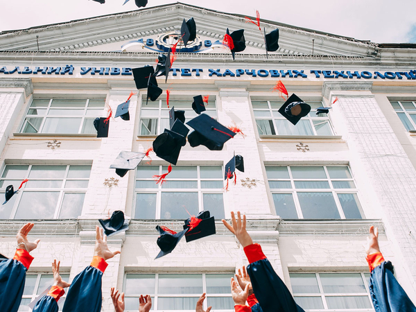 students tossing caps