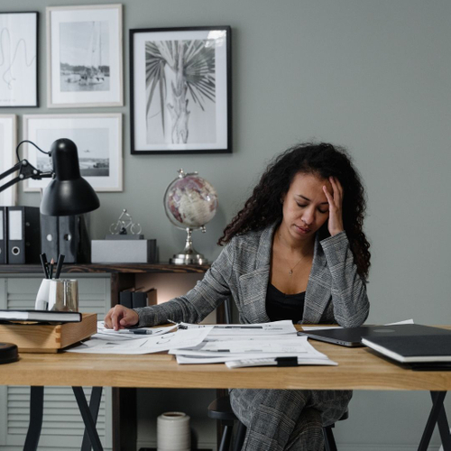 overwhelmed woman looking at paperwork