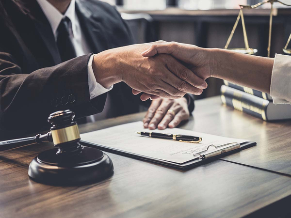  lawyer shaking hands with a client