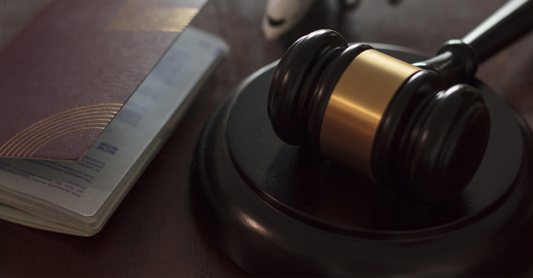 Image of a Judge's Gavel and a Passport