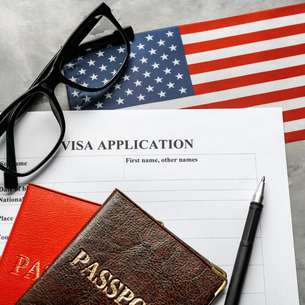 Two passports on top of a visa application