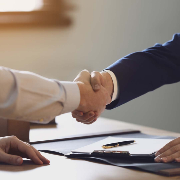 a client and a lawyer shaking hands