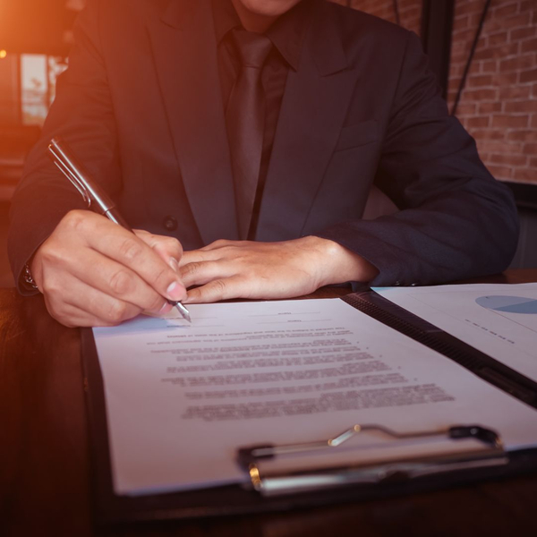 A client signing E-2 visa paperwork Blog - picture 3 - How Can Âé¶¹TV Law PLLC Help Me Get an E-2 Visa.jpg