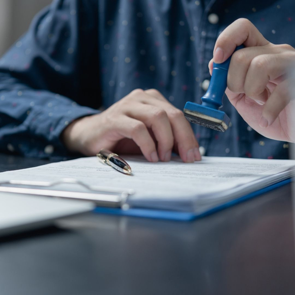person stamping paperwork