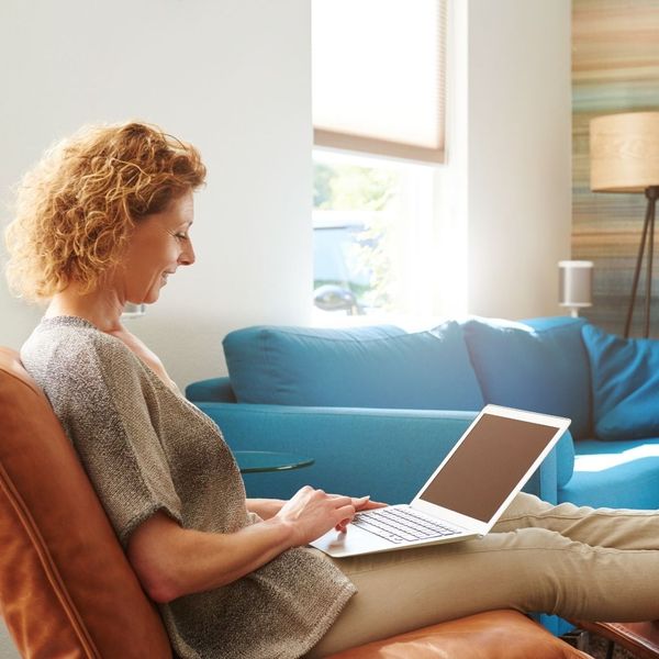 woman working on her laptop in apartment woman working on her laptop in apartment