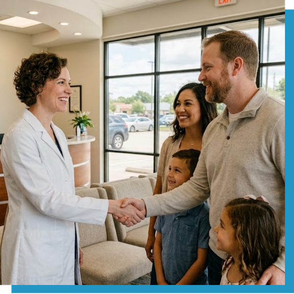 New Caney eye optometrist warmly greeting a family in the reception area