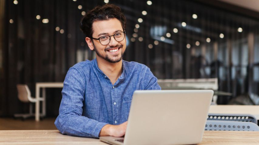 man with glasses on laptop