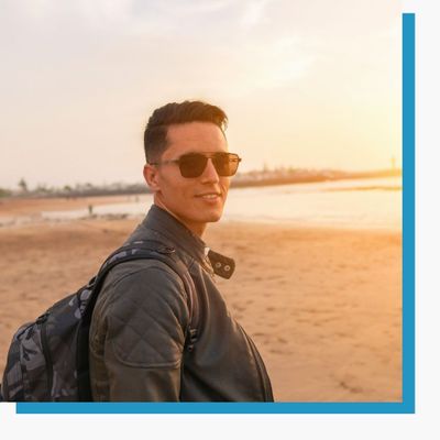 man wearing sunglasses on the beach