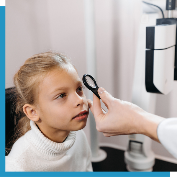 administering eye exam to little girl
