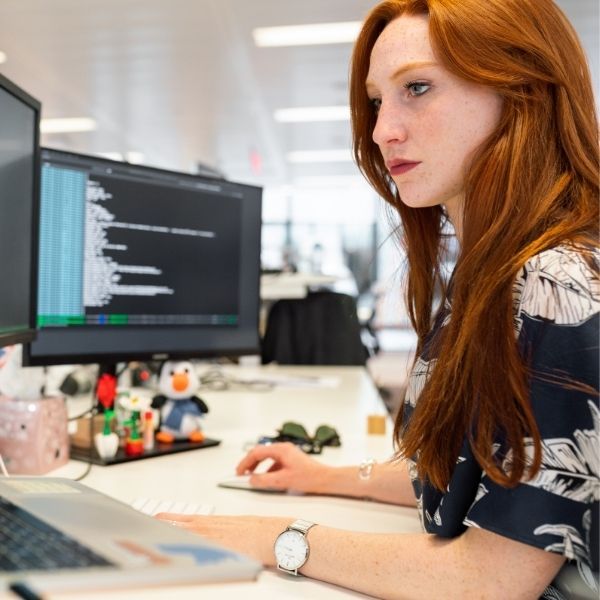 woman staring intently at work screen