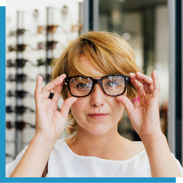A woman trying on glasses.