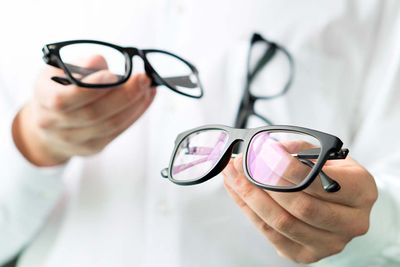 Optician-Holding-Glasses_1280x853.jpg