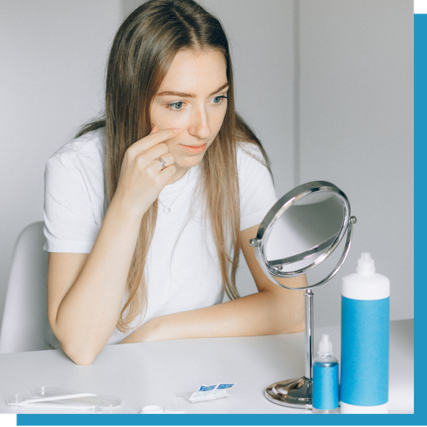 woman putting in contacts 