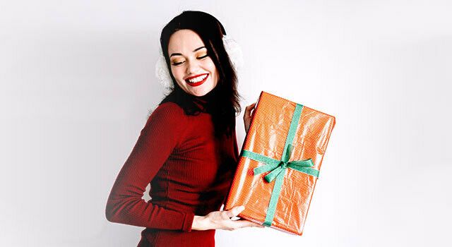 woman-in-holiday-dress-w-gift.jpg
