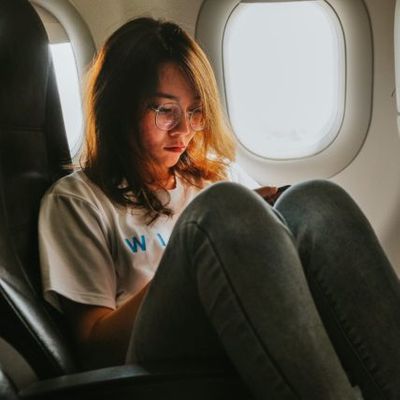girl-on-cellphone-in-airplane-e1606056089689-427x427.jpeg