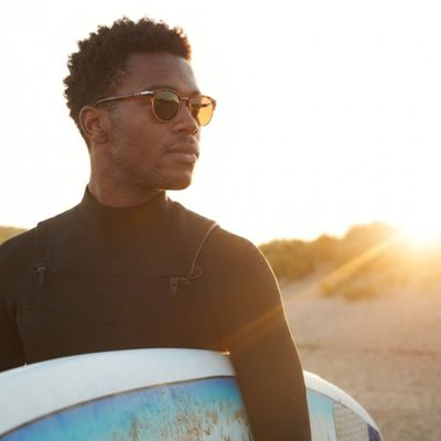 man wearing sunglasses while surfing 