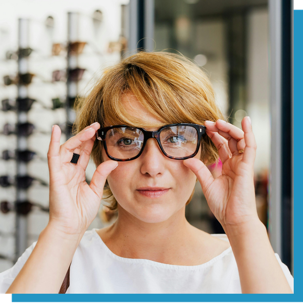 person putting on new glasses