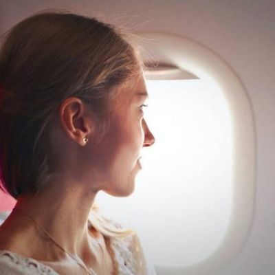 woman-on-airplane-looking-out-window-640x640-1-427x427.jpg