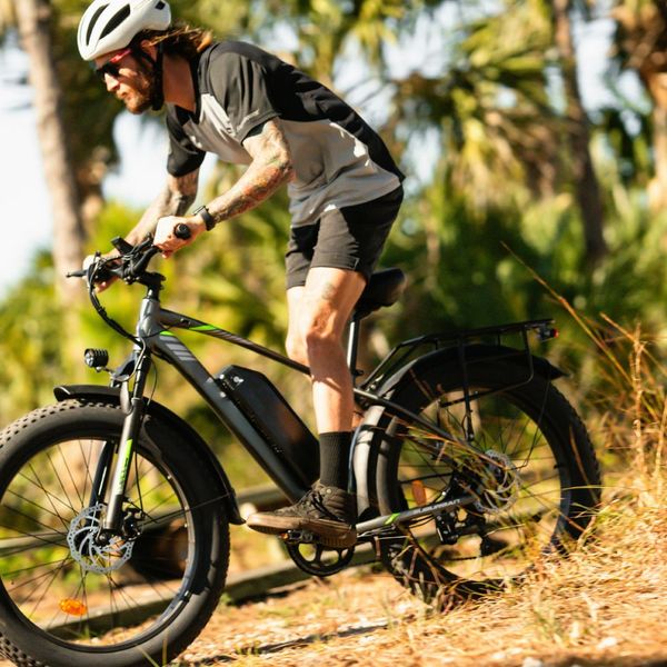 person riding electronic bike on trail