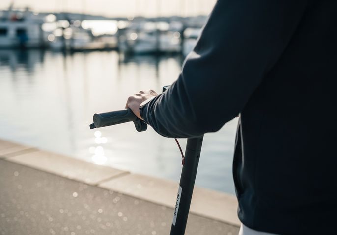 a person using a standing electric scooter 