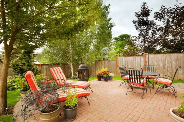 a orange colored patio with well trimmed trees