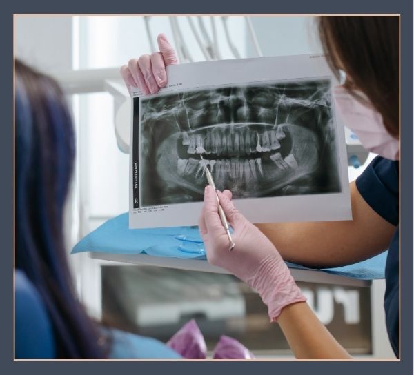 dentist showing x-ray to patient