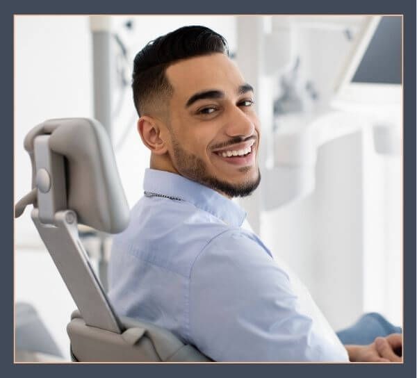 man smiling at dentist's office