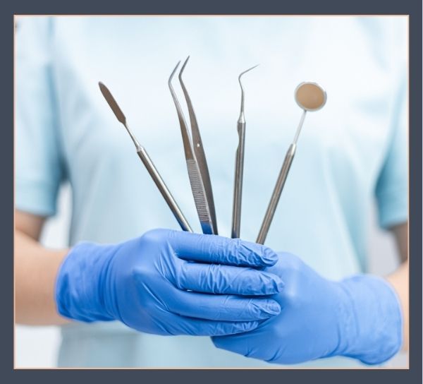 dentist holding dental tools