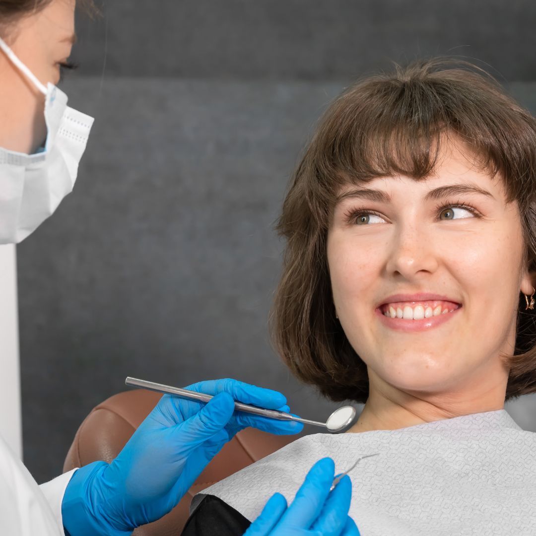 A woman smiling at a dentist