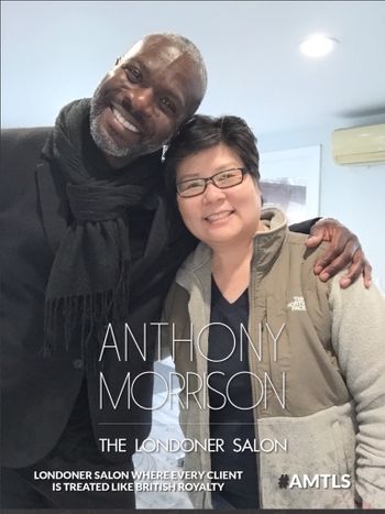 Anthony Morrison smiling while standing next to a client at THE LONDONER's hair salon in Hermosa Beach.