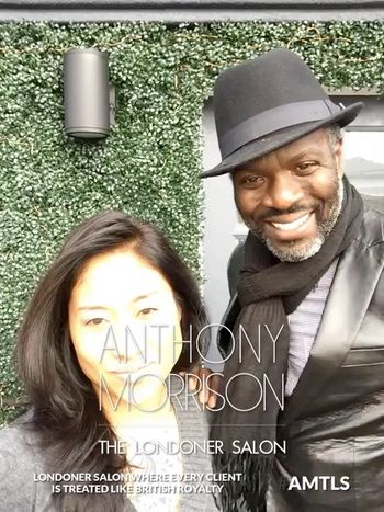 Anthony Morrison standing with a smiling client in the outdoor hair salon and text reading, "Anthony Morrison, LONDONER Salon, where every client is treated like British Royalty."
