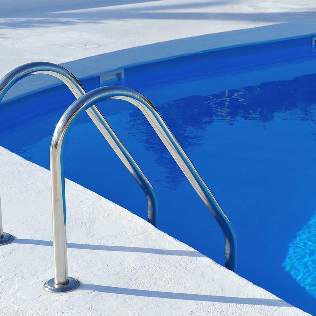 handrails leading into blue pool