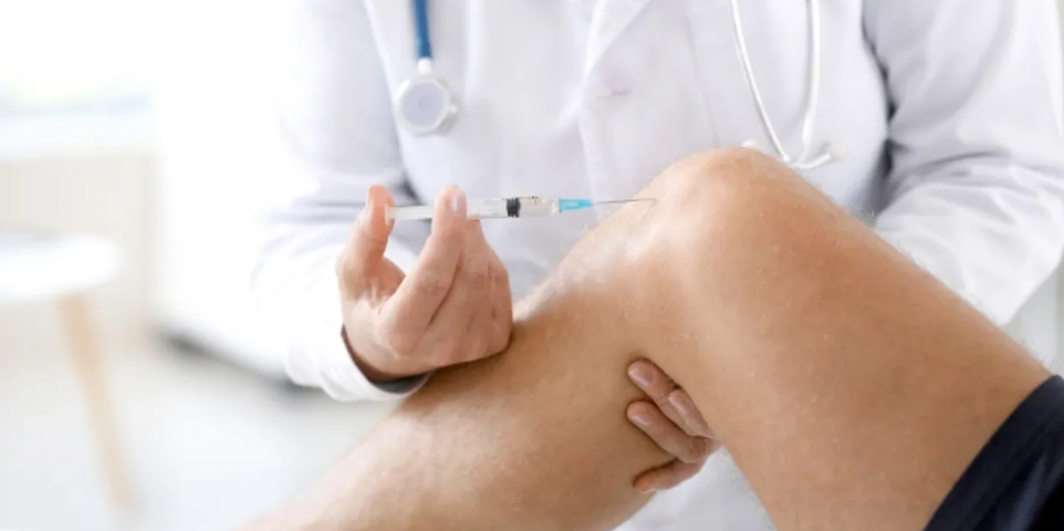 doctor injects a knee doctor injects a knee