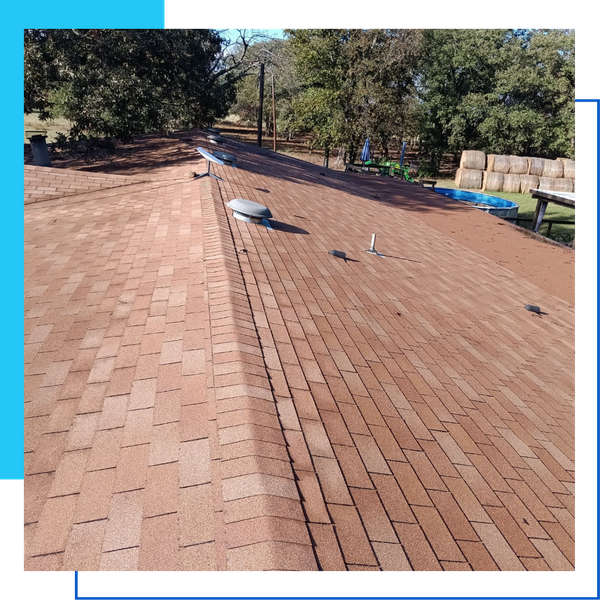 A weathered tan shingle roof showing attic ventilation caps and a mounted satellite dish.