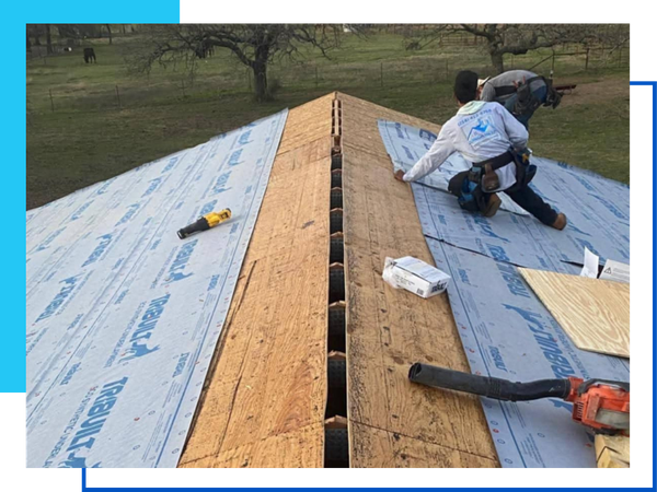 roofers wokring on the top of a roof