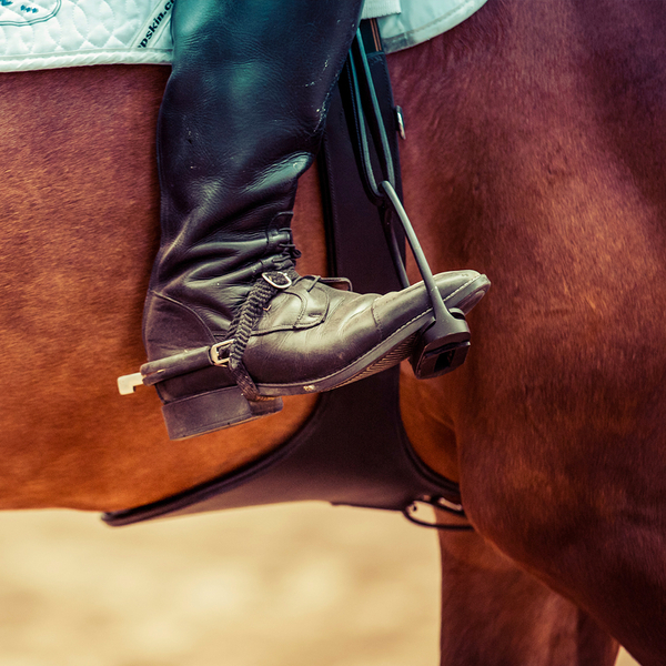 foot in a saddle stirrup