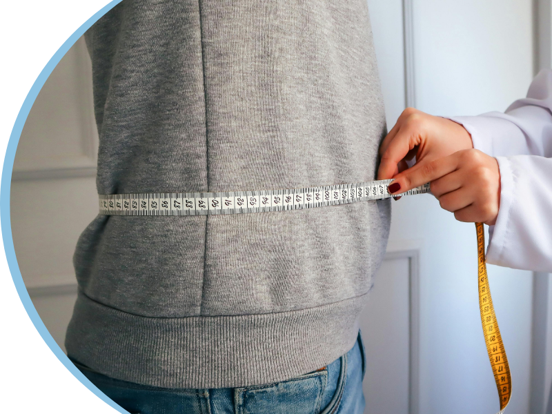 doctor measuring a patient's waist