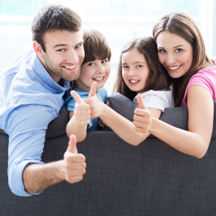 a happy family with their thumbs up