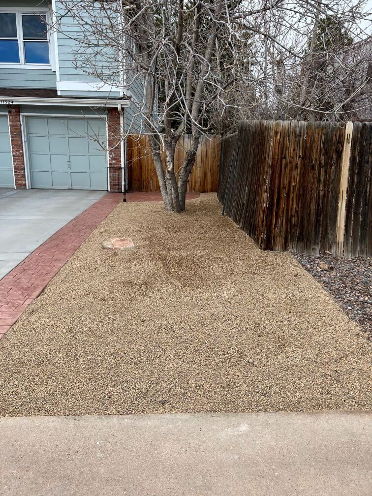 an after image of a hardscaped strip of landscaping next to a driveway