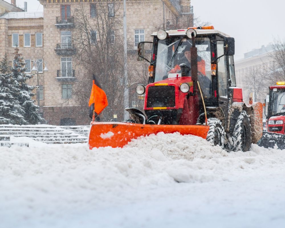 Snow being removed from a parking lot