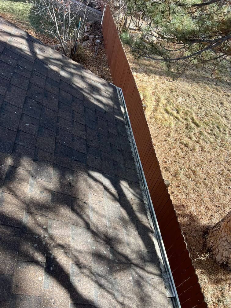 an after image of a clean roof and gutters