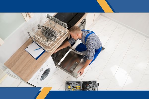 appliance repair technician working on a dish washer