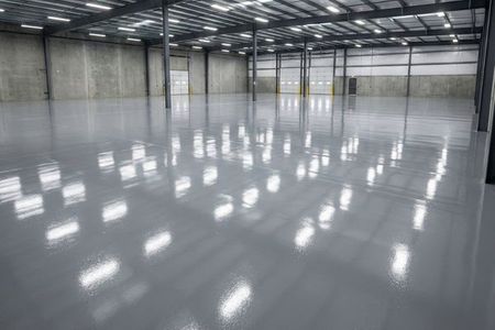 Industrial-grade commercial epoxy flooring in a large warehouse, providing a high-gloss and durable surface.