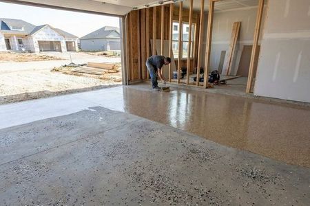A newly installed epoxy floor in a garage under construction in a new Bennington development