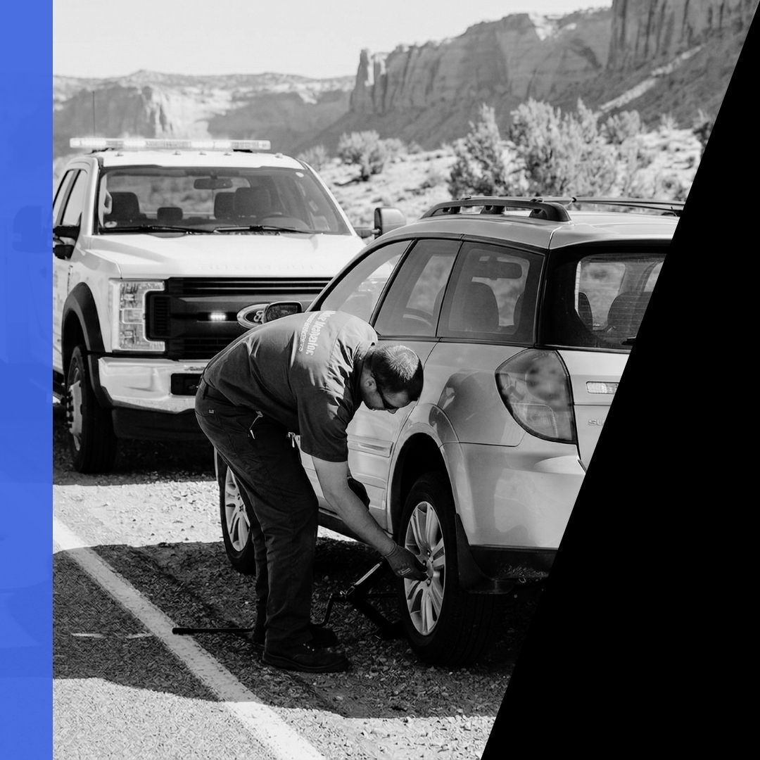 Mobile Mechanic Men technician performing a roadside tire change on a silver Subaru Outback wagon in Carbon County, Utah.