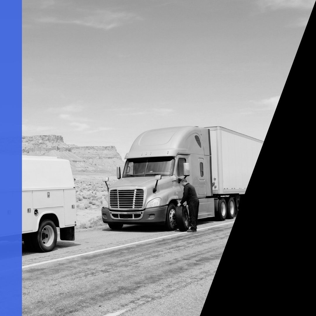 An unmarked mobile mechanic service truck providing roadside assistance to a commercial semi-truck on I-70 near Green River, Utah.