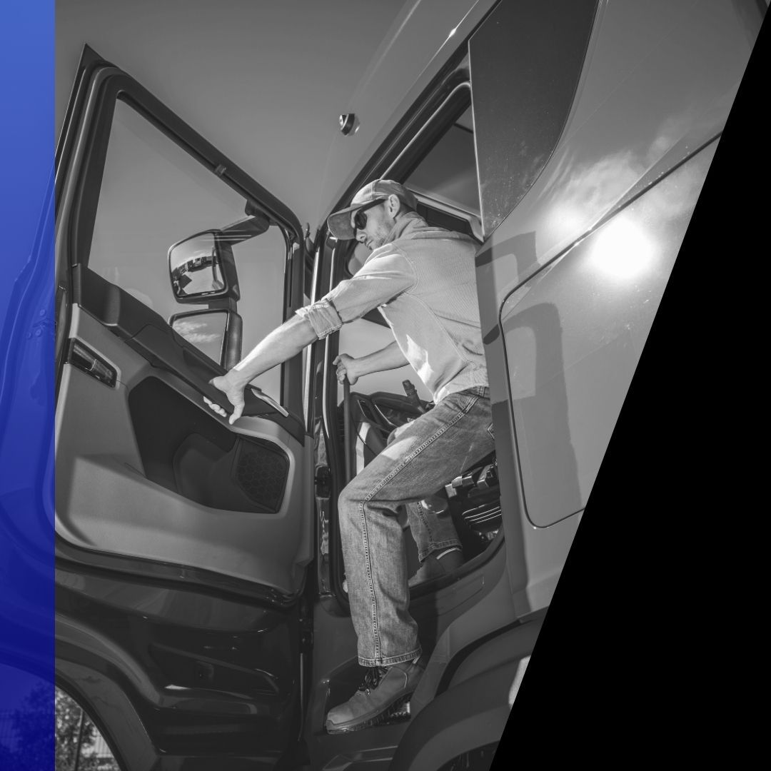 Black and white image of a semi-truck driver climbing into the cab of their truck, representing commercial mobile mechanic services.